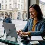 Small business owner managing social media in café