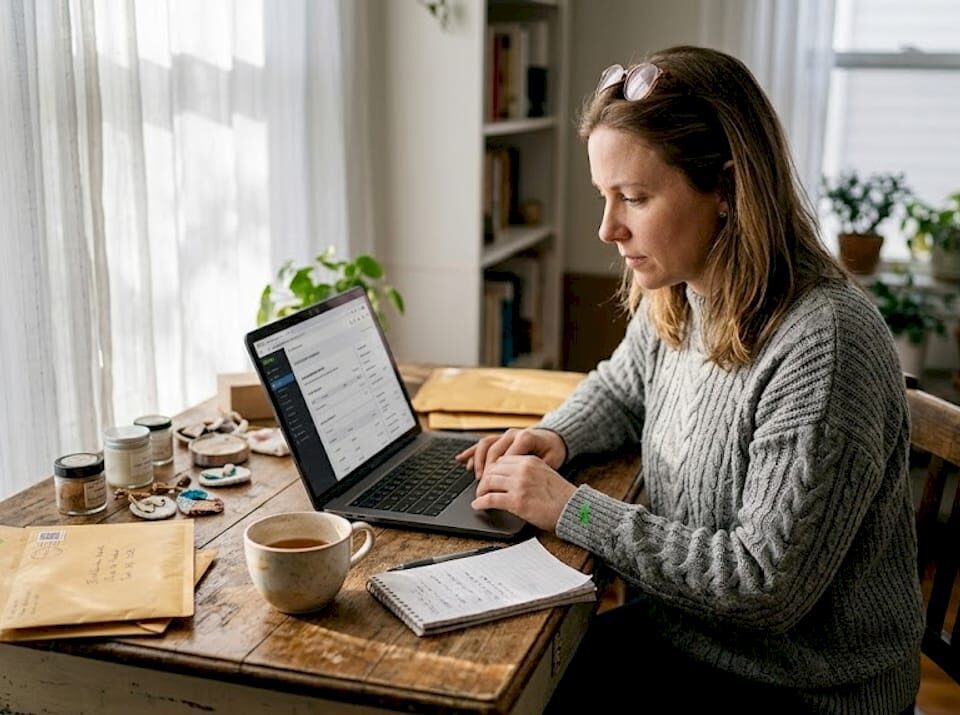 SMB owner updating ecommerce site at home