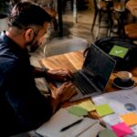 Digital marketer working on SEM campaign at home desk