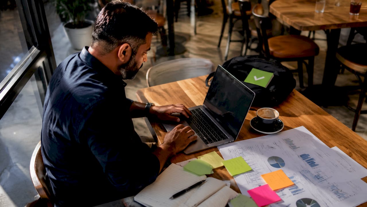 Digital marketer working on SEM campaign at home desk