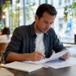 Business owner reviewing printed digital audit checklist