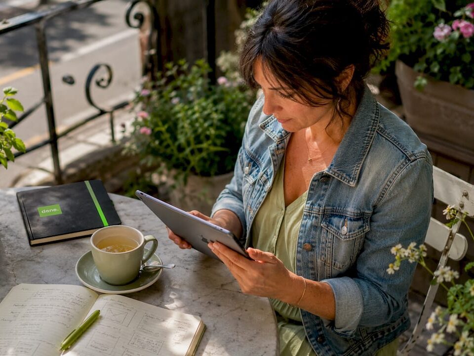 Woman reviewing digital documents in café