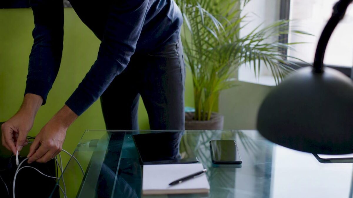 SME workspace with hands connecting a charger cable