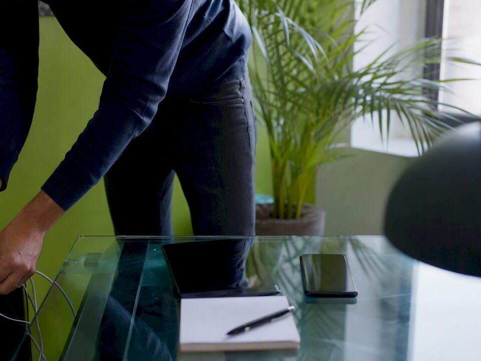 SME workspace with hands connecting a charger cable