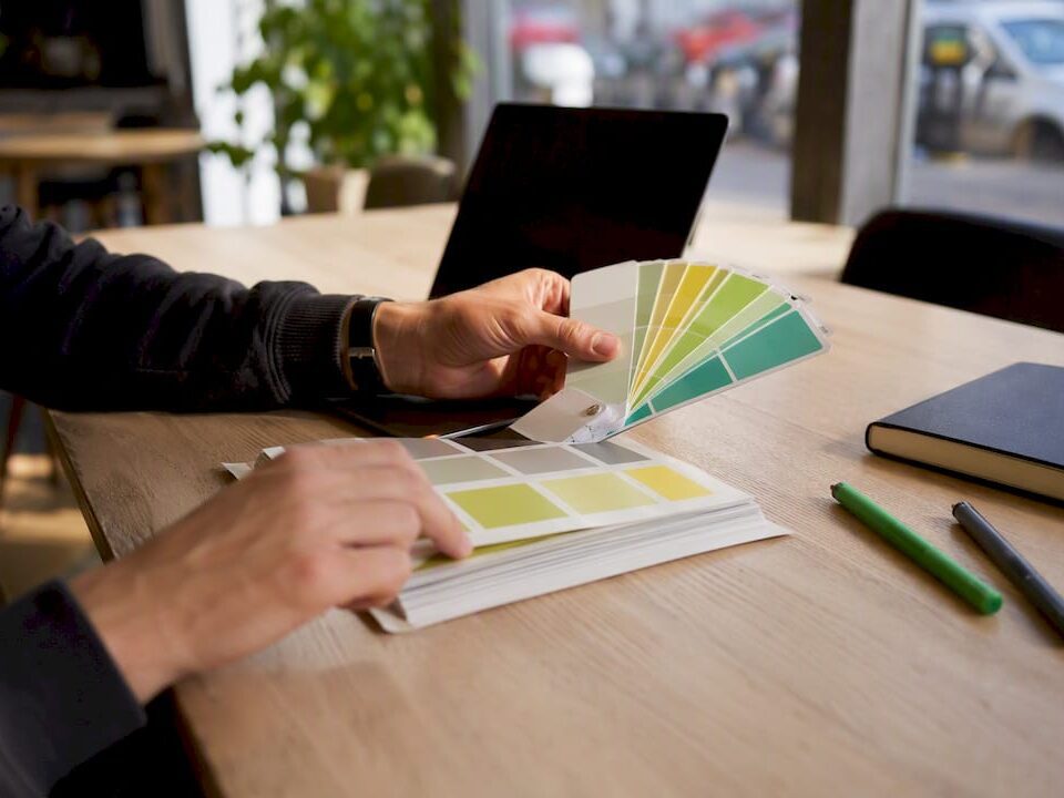 Hands adjusting color palette for branding