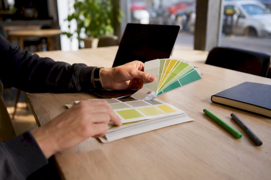 Hands adjusting color palette for branding