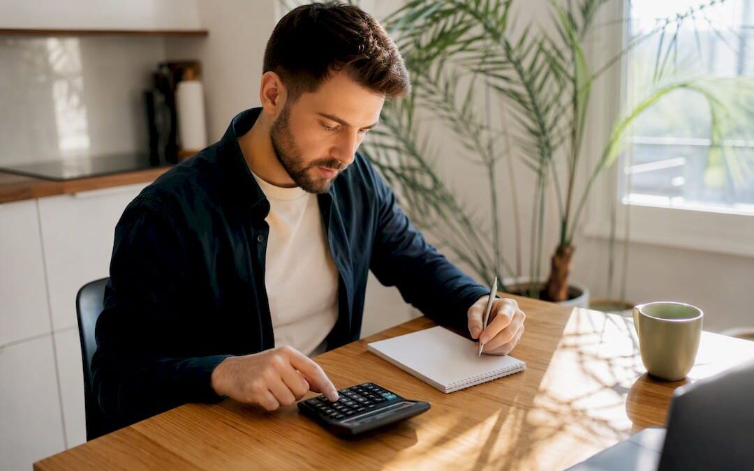 Hands calculating business budget on calculator