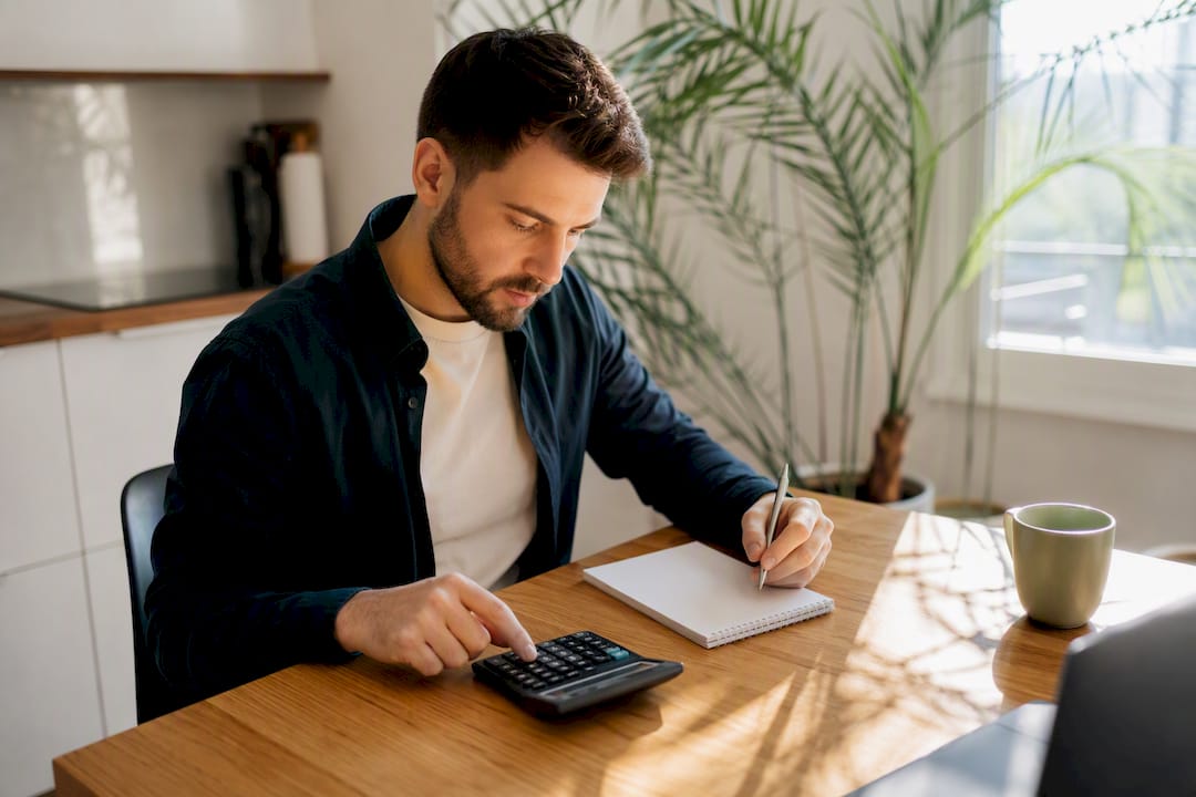 Hands calculating business budget on calculator