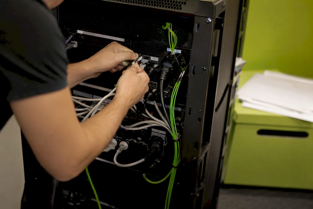 1787802335492_Hands-connecting-cables-at-a-server Hands connecting cables at a server