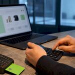 Calculator beside blurred online shop interface
